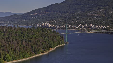 Vancouver-BC-Canada-Aerial-v77-flyover-capturing-traffic-on-Lions-Gate-Bridge-linking-Stanley-Park-and-North-shore-over-Burrard-inlet-and-West-mountain-views---Shot-with-Mavic-3-Pro-Cine---July-2023