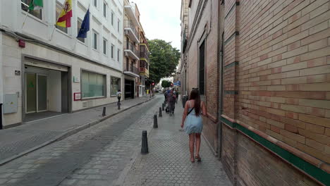 Beautiful-young-woman-walking-around-street-in-Seville-Spain-during-the-day