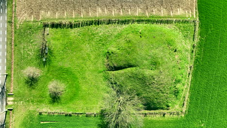 Aerial-birdseye-rsing-from-Tumulus-of-Koninksem,-Tongeren,-Belgium