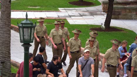 A-group-of-Australian-Defence-Force-troops-is-marching-through-the-path-of-Anzac-Square,-preparing-for-the-Anzac-Day-parade,-handheld-motion-close-up-shot