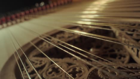 grand-piano-strings,-no-camera-movement,-closeup,-slow-motion,-yellow-wood,-dark