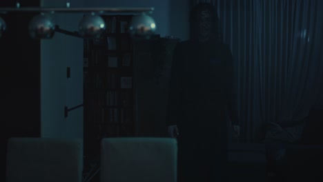Horror-scene---a-dark-and-ominous-demon-walks-through-a-ghastly-living-room-at-night