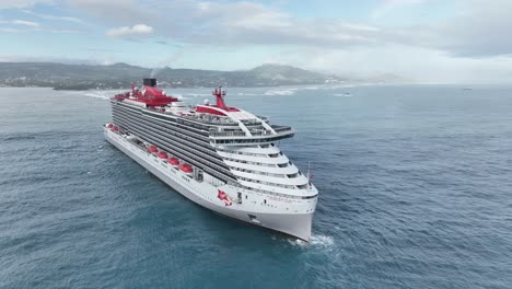 Virgin-cruise-ship-arriving-at-port-of-Puerto-Plata-in-Dominican-Republic,-aerial-drone-pov