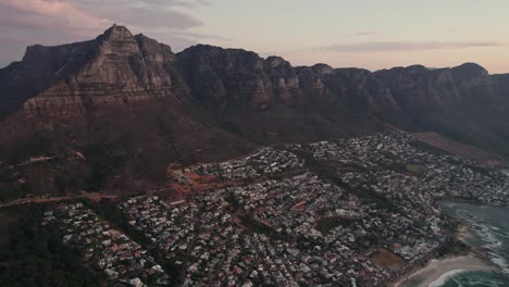 Camps-Bay-Suburb-With-Table-Mountain-National-Park-In-The-Background-At-Dusk-In-Cape-Town,-South-Africa