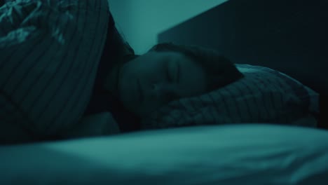 Close-up-of-woman-turning-in-bed-and-falling-asleep