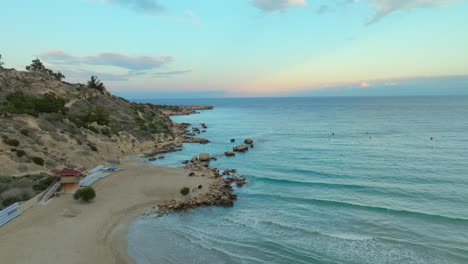 Sandy-beach,-ocean-and-coastline-of-Cyprus-at-sunset-time