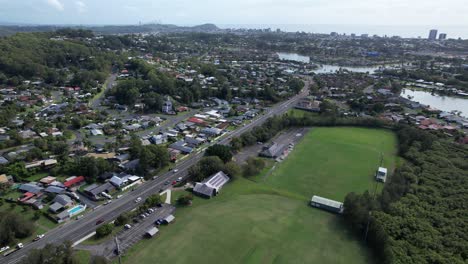 Cars-Driving-Through-Galleon-Way-Along-Merv-Craig-Sports-Ground-And-Recreation-Park-In-Currumbin-Waters,-QLD,-Australia