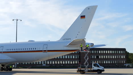 Crew-carrying-out-inspection-on-German-Luftwaffe-Airbus-on-sunny-day,-Cologne