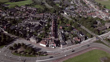 Cars-passing-by-on-ring-road-around-residential-neighbourhood-De-Hoven-in-Zutphen,-The-Netherlands