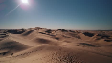 Drone-flying-in-Glamis-Sand-Dunes-California-desert-while-chasing-dune-buggies