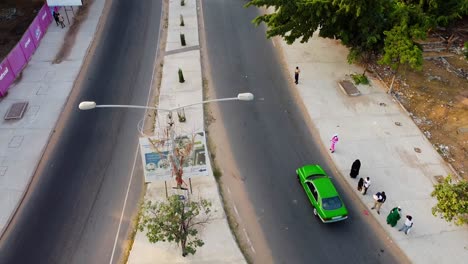 Aerial-view-flying-over-highway-roundabout-from-arch-22-entrance-of-Banjul-city,-Gambia
