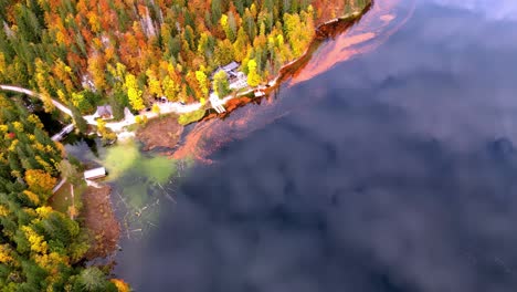 A-beautiful-view-of-a-golden-lake-with-a-dock-and-trees-in-the-background