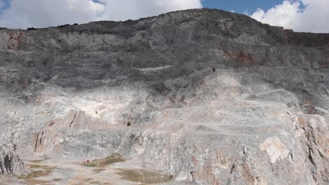 Drone-flight-old-empty-abandon-quarry-clouds-shadow-on-top-sunny-day