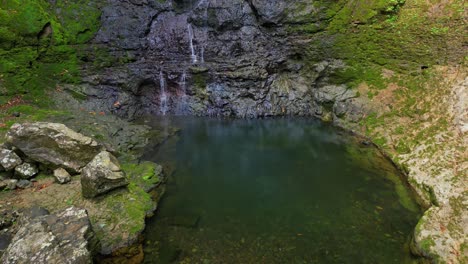 Flying-over-the-lake-created-by-the-waterfall-Oque-Pipi-and-rising-the-the-view-and-being-able-to-enjoy-the-waterfall-in-Prince-Island,São-Tomé,Africa