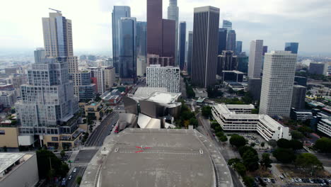 Los-Angeles-USA,-Aerial-View-of-Walt-Disney-Concert-Hall,-Downtown-Buildings-and-Traffic,-Drone-Shot
