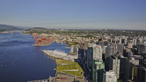 Vancouver-BC-Canada-Aerial-v35-drone-flyover-the-harbour-capturing-landmark-Canada-place,-waterfront-downtown-cityscape-and-Eastside-Centerm-container-terminal---Shot-with-Mavic-3-Pro-Cine---July-2023