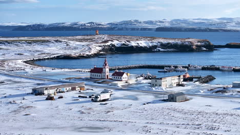Zoomed-drone-lowering-view-of-a-traditional-church-in-the-viking-city-Raufarhöfn-during-winter-time