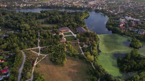 Mogoșoaia-palace-and-surrounding-green-parklands-at-sunset,-aerial-view