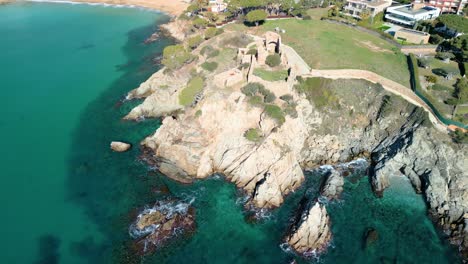 High-above,-La-Fosca's-coastline-invites-guests-to-embark-on-a-journey-of-discovery,-with-the-castle-serving-as-a-gateway-to-a-world-of-luxury,-history,-and-natural-beauty-along-the-Costa-Brava