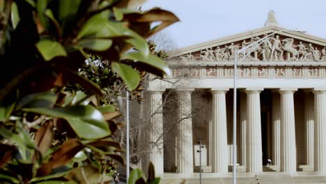 The-Partehnon-building-in-Nashville,-Tennessee-close-up-with-magnolia-tree-in-foreground-video-panning-right-to-left