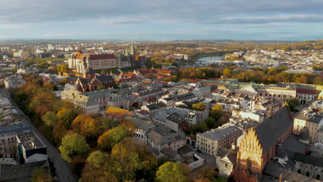 Panorama-of-soft-lighted-Old-Town-and-Wawel-Castle-at-colorful-autumn-morning-during-cloudy-weather,-Krakow,-Poland