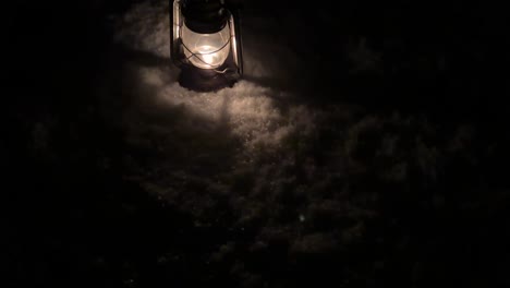 Old-antique-oil-lantern-retro-kerosene-lamp-oil-in-snow-in-backyard-the-vintage-copper-oil-lamp-in-winter-season-light-fire-flame-burning-fuel-to-light-in-darkness-in-rural-life-Iran-local-people-town