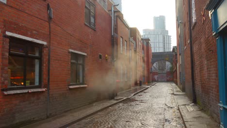 Smoke-From-Industrial-Building-On-Alleyway-In-Moss-Side,-Manchester,-UK