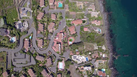 Aerial-top-down-rotating-descend-shot-of-the-residential-village-near-Catania,-Sicily,-Italy