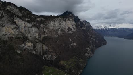 Profile-view-of-mountains-and-hills-during-winter-season-under-cloudy-sky-in-Walensee,-Switzerland