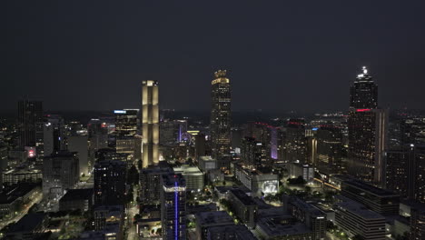 Atlanta-Georgia-Aerial-v908-reverse-flyover-Sweet-Auburn-capturing-illuminated-downtown-cityscape,-freeway-traffic-and-lightning-strikes-over-the-sky-at-night---Shot-with-Mavic-3-Pro-Cine---May-2023