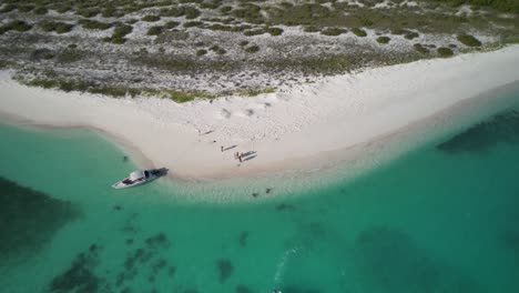A-serene-beach-at-los-roques-with-clear-waters,-sunny-day,-aerial-view