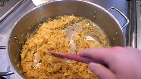 Caramelized-onion-being-stirred-with-a-spatula-by-the-chef