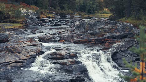A-mountain-river-surrounded-by-stark-northern-landscape-cascades-in-the-rocky-riverbed