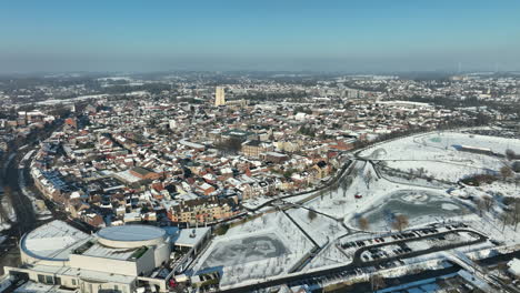 Tongeren-City-Aerial-Panoramic-Cityscape-on-a-Snowy,-Sunny-Winter-Day