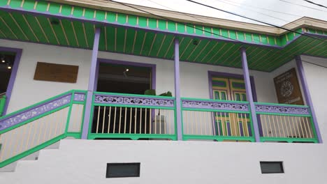 Passing-by-Colorful-Colonial-Style-buildings-from-Salento,-view-from-car,-Colombia