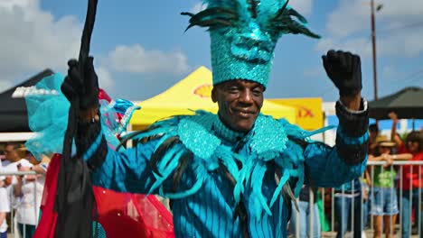 Old-black-man-dances-wearing-turquoise-blue-suit-for-carnaval-parade