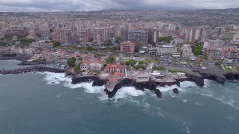 Aerial-wide-orbit-over-the-waterfront-of-Catania,-Sicily,-Italy