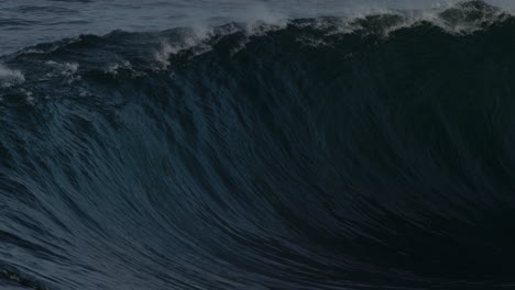 Surfer-pulls-back-on-board-as-powerful-wave-glistens-as-it-breaks