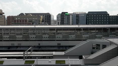 Daytime-scene-capturing-Kyoto-Station-and-the-Shinkansen-railway-lines,-representing-the-fusion-of-urban-architecture-with-contemporary-transportation-in-Japan