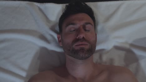 Caucasian-middle-aged-man-meditating-on-special-water-matress-in-a-french-Spa