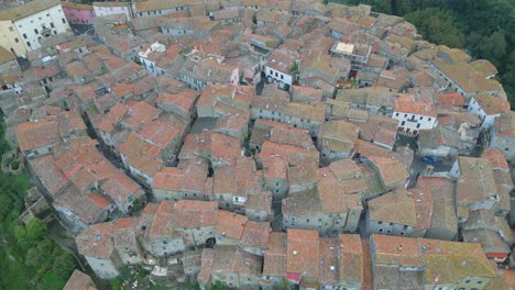 Aerial-view-of-a-medieval-town-in-Italy,-the-drone-camera-tilts-down
