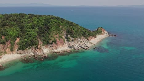 Panoramic-aerial-drone-fly-cliff-above-white-coastline-beach-in-Wakayama-Japan-blue-ocean-pacific-waves-in-turquoise-coral-water,-pristine-nature-in-Japanese,-asian-travel