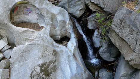 Moving-Aerial-View-of-Heartrock-in-Crestline-California---Natural-Rock-Formation-with-Flowing-Waterfall