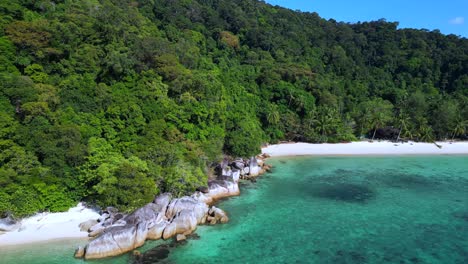 Tropical-paradise-secluded-serene,-sandy-beach-alongside-lush-forest-clear-blue-water