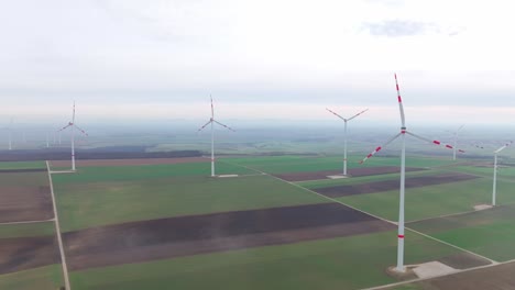 Wind-Farm-Turbines-Stands-On-Rural-Landscape-On-A-Misty-Morning