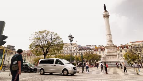 Rossio-Square-in-Slow-motion,-People-and-traffic-commute-in-Lisbon-downtown