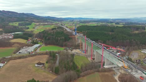 Aerial-View-Of-A-Tower-Cranes-On-Construction-Of-A-New-Motorway-Bridge