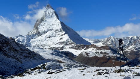 Camera-tripod-Lake-Riffelsee-Zermatt-Switzerland-Glacier-Gornergrat-Railway-train-stop-autumn-October-clear-afternoon-blue-sky-The-Matterhorn-peak-first-snow-landscape-scenery-Swiss-Alps-slider-right