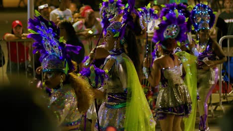 Closeup-of-womans-feet-dancing-during-Carnival-pans-to-smiling-vibrant-face-at-night