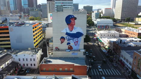 Aerial-view-away-from-the-Shohei-Ohtani-mural,-on-the-Miyako-hotel-wall-in-Los-Angeles,-USA
